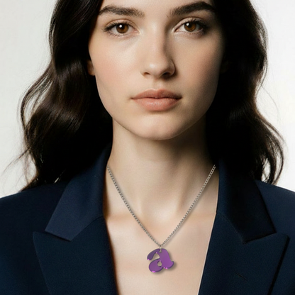Woman wearing a necklace with a purple pendant against a neutral background