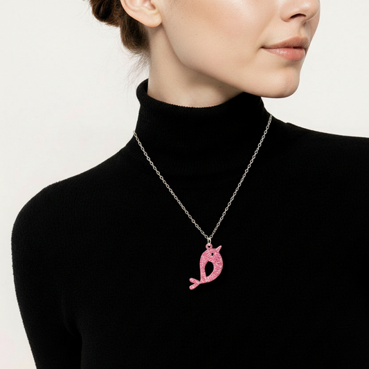 Person wearing a black turtleneck with a pink pendant necklace on a white background