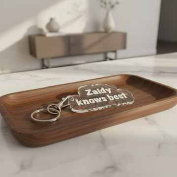 Wooden tray with 'Zaddy knows best' plaque on a marble surface